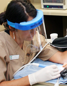 Veterinary Technician Performing Dental Cleaning 