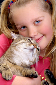 Girl hugging cat.